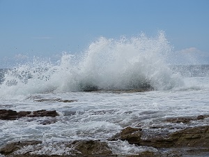 Ocean Wave Crashing Over Rocks