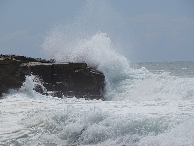 Ocean Wave Crashing Over Rocks