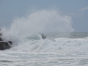 Ocean Wave Crashing Over Rocks